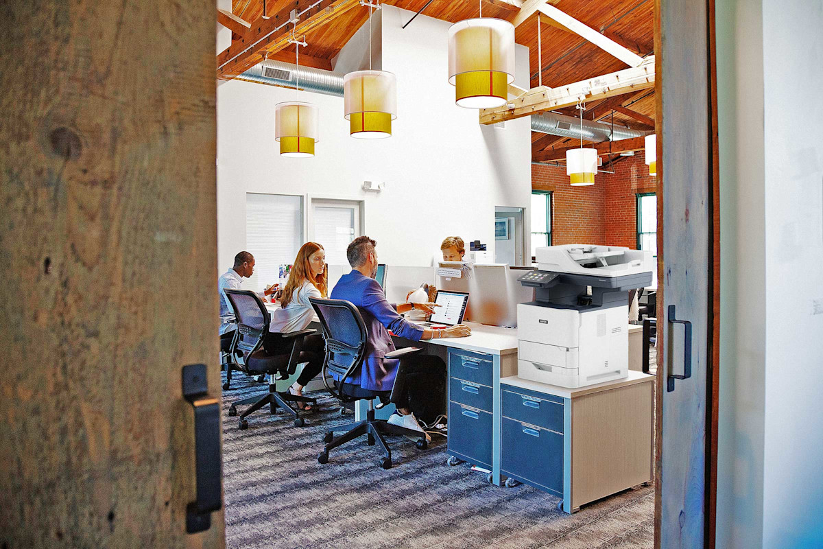 Technician installing commercial copier in Houston office
